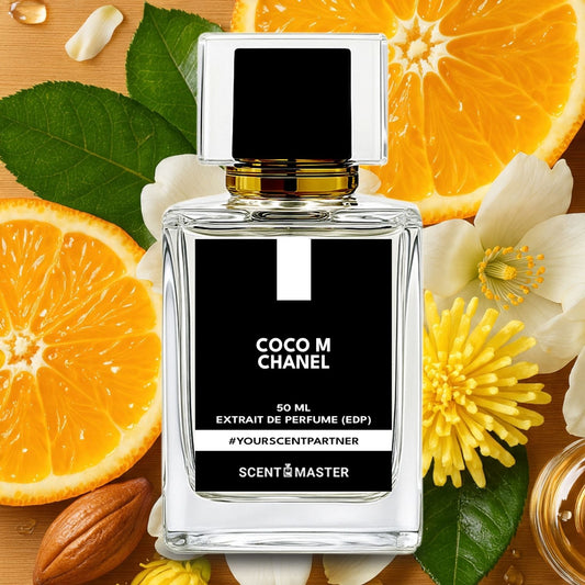 Perfume bottle labeled 'Coco M Chanel' surrounded by oranges, flowers, and leaves on a wooden surface.