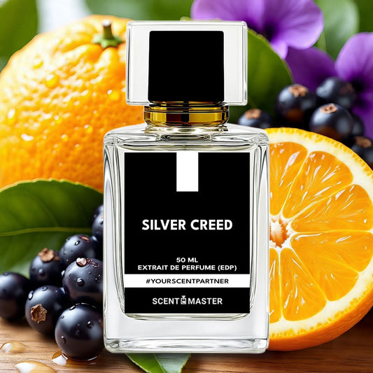 Perfume bottle labeled 'Silver Creed' with oranges and berries on a wooden surface