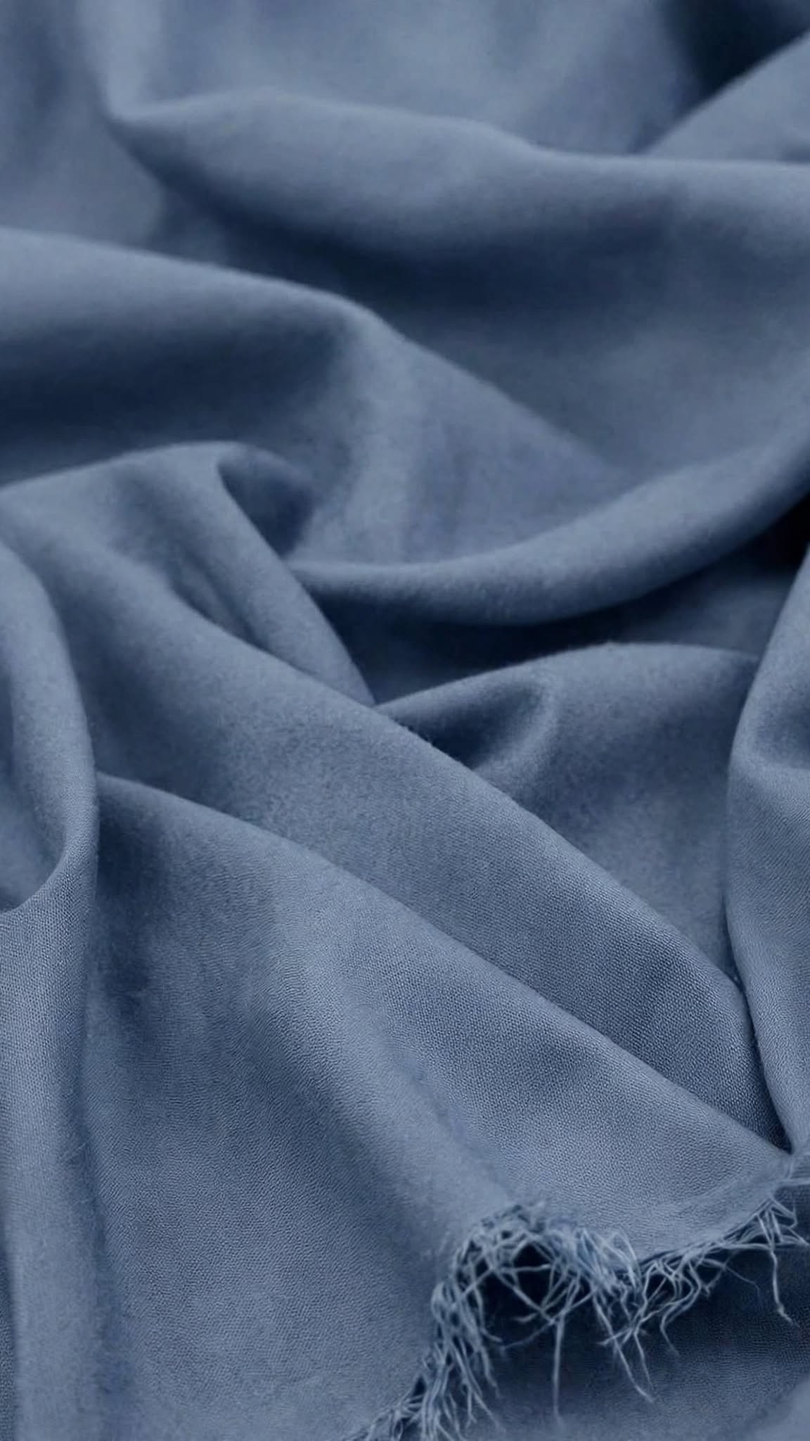 Cedar Blue Breeze Wash and Wear unstitched fabric in soft folds with a frayed edge, Libas-E-Andalus