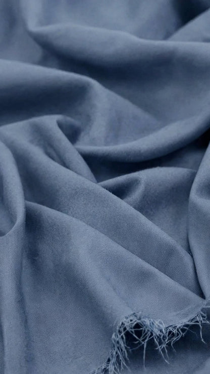 Cedar Blue Breeze Wash and Wear unstitched fabric in soft folds with a frayed edge, Libas-E-Andalus