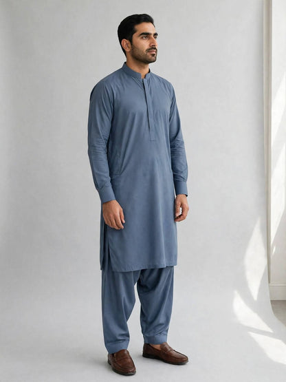 Man wearing a styled example of a Cedar Blue kameez shalwar tailored from Libas-E-Andalus Breeze Wash and Wear fabric