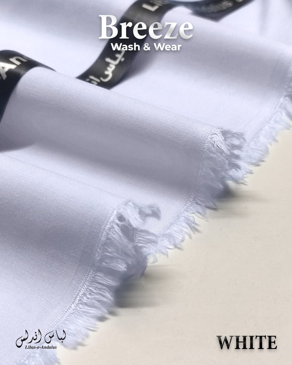 White fabric with frayed edges and 'Breeze Wash & Wear' branding on a light background.
