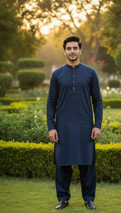 Man in a navy blue pasha cotton kurta standing in a garden