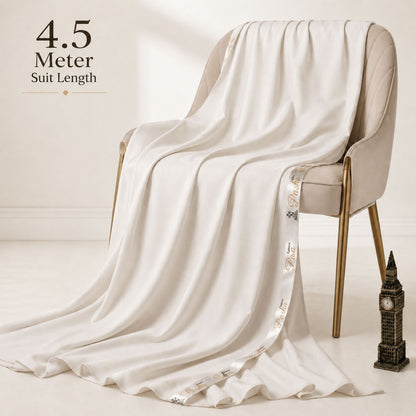 Pasha Premium Cotton Off White 4.5 meter unstitched suit fabric draped over a chair showing smooth fall and premium cotton texture.