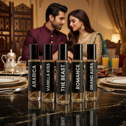 Five perfume bottles labeled 'Arabica', 'Vanilla Kiss', 'The Beast', 'Romance', and 'Grand Aura' on a table with a couple in the background.